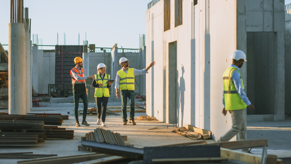 Diverse,Team,Of,Specialists,Taking,A,Walk,Through,Construction,Site.